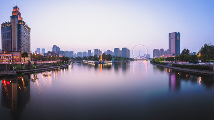 Fototapeta na wymiar Night scene cityscape of Tianjin ferris wheel,Tianjin eyes in twilight time.Most Modern and popular landmark in Tianjin city.
