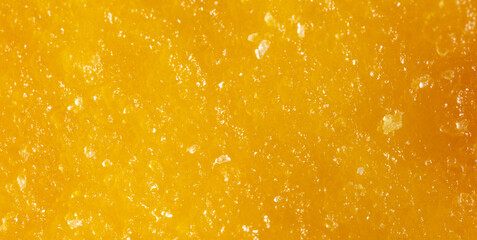 Dried yellow mango pulp as background.