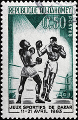 Boxers in a match on vintage african stamp