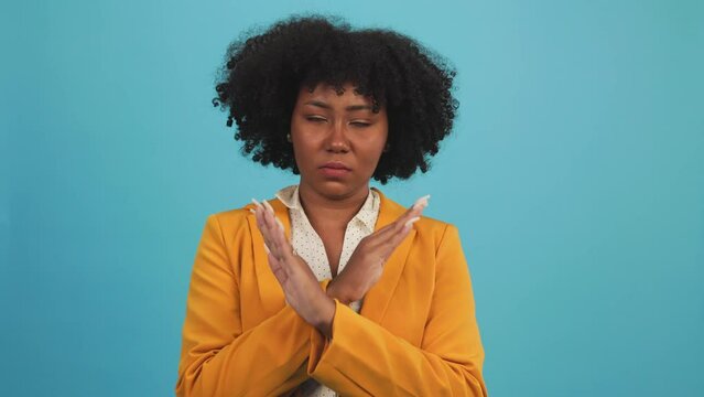 African american woman over isolated blue background making NO gesture.