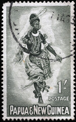 Fototapeta na wymiar Indigenous woman dancing on stamp of Papua New Guinea