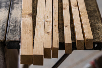 Wooden carpentry boards ready for processing lie on the table 