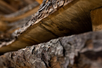Large boards of natural tree with bark in the workshop, carpentry shop 