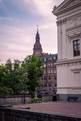 Fototapeta na wymiar The historic university building and a park during summer sunset in Lund Sweden