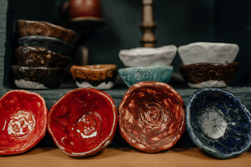 Multi-colored clay plates on the mantelpiece