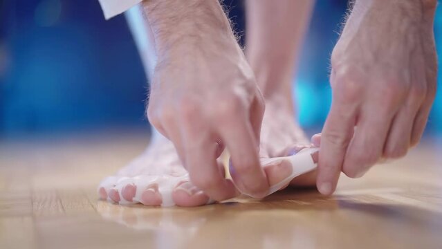 Putting on silicone medical toe corrector against hallux valgus joint strain 4K