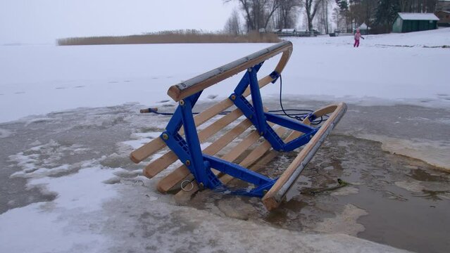 Wooden Sled on Thin Ice Lake, Danger of Drowning in Ice-Hole in Winter