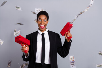 Photo of young impressed girl guy have fun shoot money gun profit isolated over grey color...