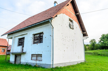 Abandoned House Remained Damaged after the Civil War in Croatia. Walls are full of Bullet Holes and...
