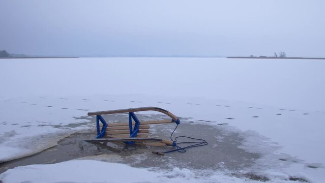 Wooden Sled on Thin Ice Lake, Danger of Drowning in Ice-Hole in Winter