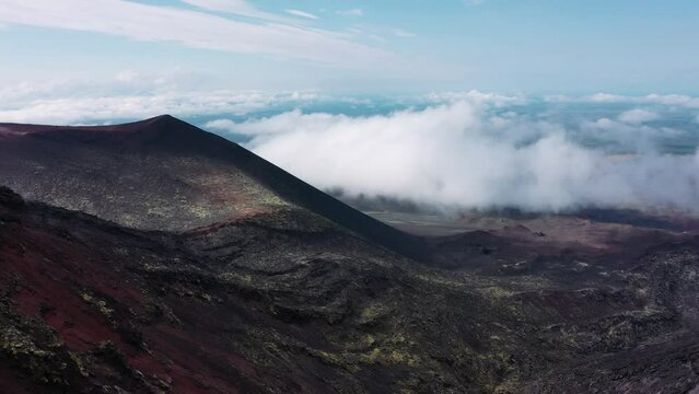 Woman traveler walking against background of active Tolbachik volcano, Kamchatka. Aerial drone video