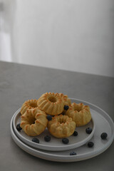 Mini bundt cakes with fruits on plate on a gray table. Breakfast. Copy space