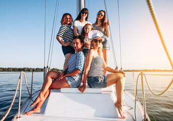 Group of women relaxing on luxury yacht . Having fun together while sailing in the sea. Traveling...