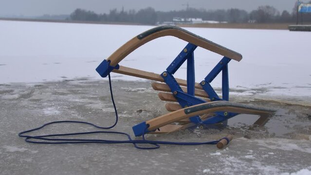 Wooden Sled on Thin Ice Lake, Danger of Drowning in Ice-Hole in Winter