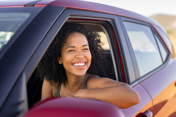 Black young woman looking outside car - Powered by Adobe