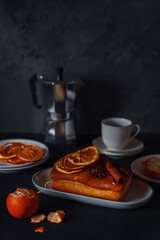 Home baked orange and cinnamon pound cake, coffee and fruit for breakfast