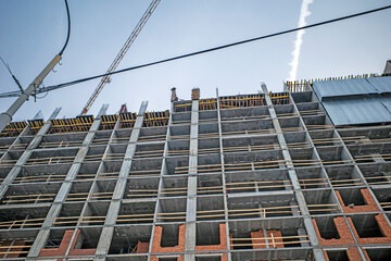 The upper part of a multi-storey building under construction on a winter day