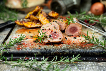 Pork tenderloin chops served with potatoes and rosemary