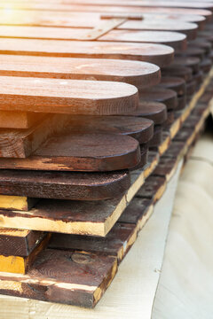 Close-up, A Large Section Of A Wooden Fence Lying In A Pile After Being Painted With Brown Paint