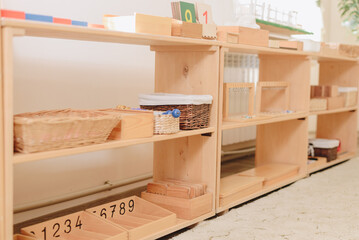 wooden shelf with materials for Montessori studies. study of chickens, mathematics.