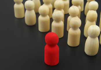 Leader and management concepts, Wooden figure stand in rows and red leader.