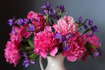 Bouquet of pink peonies and purple irises.
