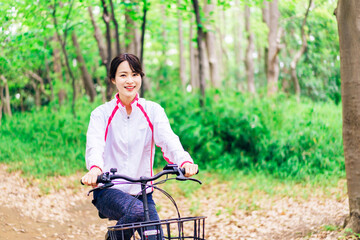 Obraz premium 自然の中でサイクリングを楽しむ若い女性