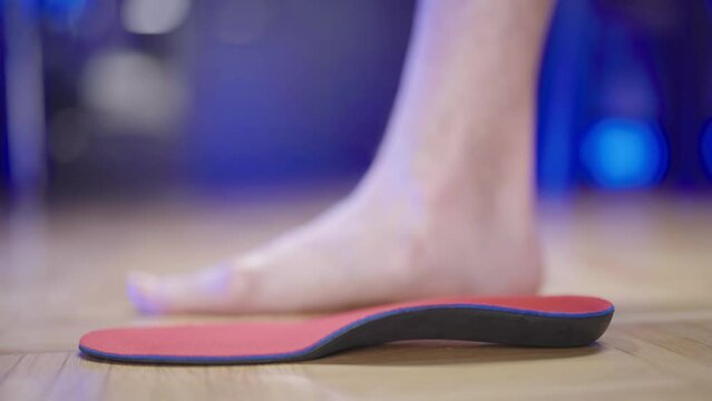 Shoe insole support for feet arch with flat feet in background 4K