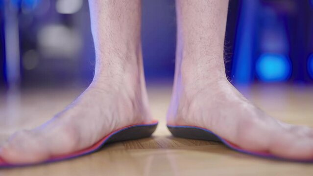 Person feet testing the arch support insole flexibility 4K