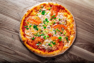pizza with tuna fish and cheese on wooden background