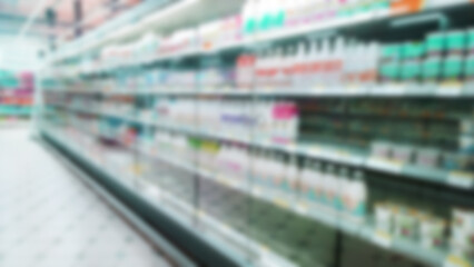 Abstract blur image of supermarket background. Defocused shelves with dairy products. Grocery. Retail industry. Rack. Discount. Inflation and crisis concept. Aisle. Consumer packaged goods. CPG. Store