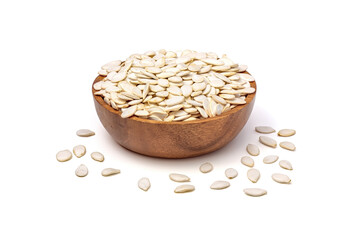 Pumpkin seeds in shell isolated on white background. Unpeeled pumpkin seeds in wooden bowl top view.