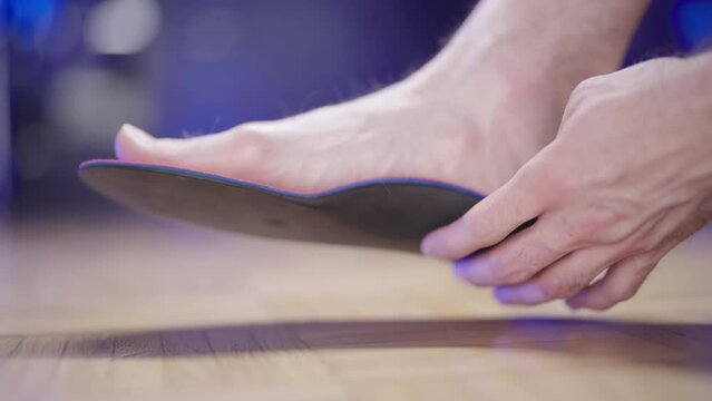 Person barefoot trying out shoe insole 4K