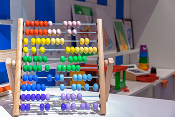 Multi-colored wooden abacus in the interior of the children's room.