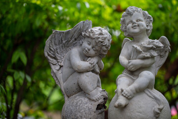 Fototapeta na wymiar Sculpture of angel in the park. Image made vintage tone.