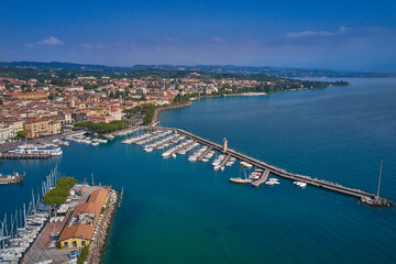 Aerial panorama of the town of Desenzano del Garda on Lake Garda in Italy. Italian resorts on Lake Garda. Aerial view of Desenzano del Garda. Top view of the boat parking on the lake.