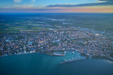 View from city of Desenzano del Garda, Italy, on sunny summer day. Natural background. Drone view of Desenzano del Garda. Aerial view. Beautiful Garda Lake with lighthouse (Lago di Garda).