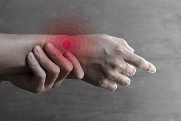 Inflammation of Asian man wrist joint and hand. Concept of joint pain and hand problems.