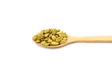Spice Green Cardamom on wooden spoon isolated on white background. Green cardamom is a fragrant herb used as an ingredient for cooking. 