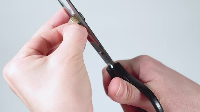 Destruction of the smartphone's SIM card with scissors. The communication card is cut into two halves.