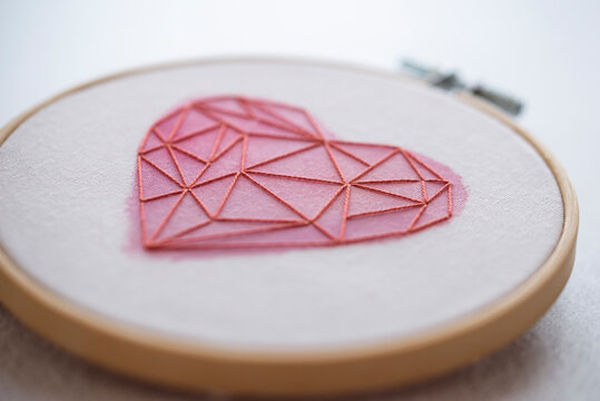 Close-up Of An Embroidery Hoop With A Heart Shape Motif