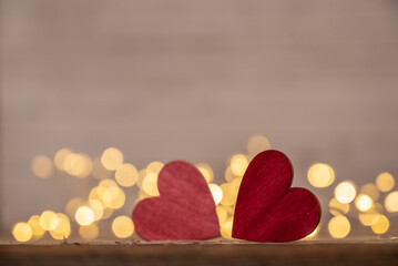 Obraz premium Red heart, valentine's day greeting card. Bokeh background. Two hearts on wooden background with bokeh lights