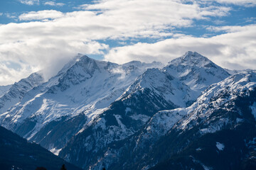 
foehn clouds on the horizon and sahara dust in the air at a sunny spring day in the austrian alps