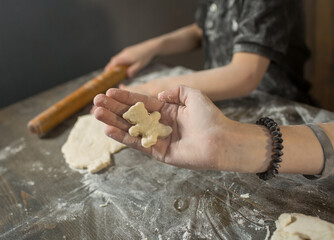 brother and sister sculpt cookies, close-up of a hand with cookies in the shape of a bear