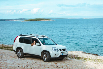 Fototapeta na wymiar woman in white suv car at sea beach. bay on background