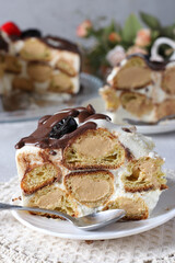 Profiterole Cake, cut into portions, one piece in the foreground, Close-up