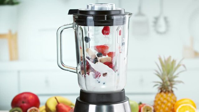 Super slow motion of mixing pieces of fruits with milk in blender. Filmed on high speed cinema camera, 1000 fps. 