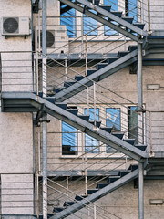 Sloping metal staircase on the facade of the house