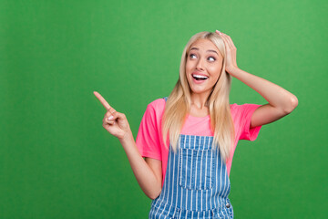 Photo of excited crazy lady direct fingers empty space discount banner wear striped overall...