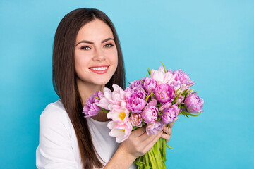 Portrait of charming positive lady receive peony and tulips flowers from her boyfriend isolated on blue color background